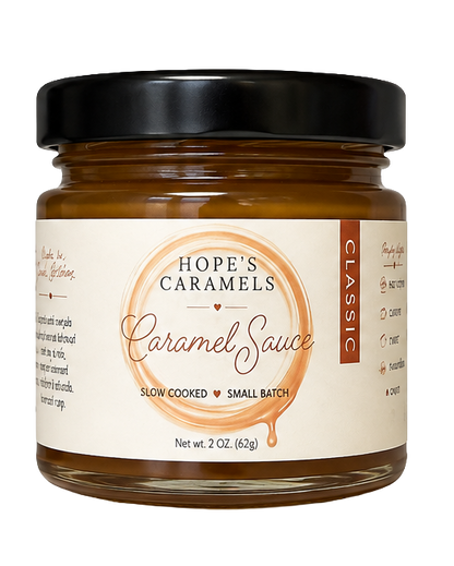 A jar of Hope's Caramels Classic Caramel Sauce with a black lid and cream label, set against a plain white background.